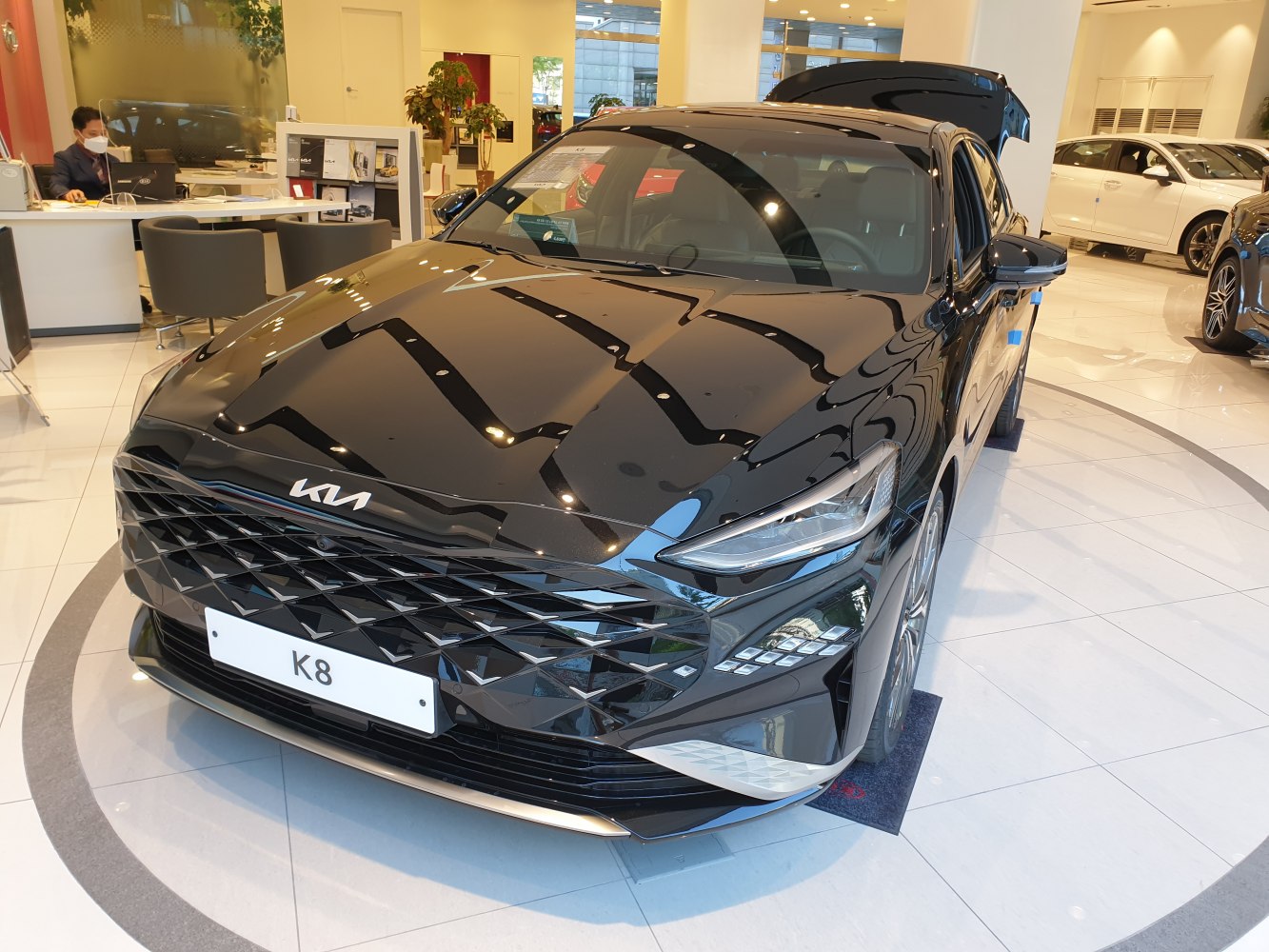 Sharp front grille and distinctive LED headlights on sleek sedan