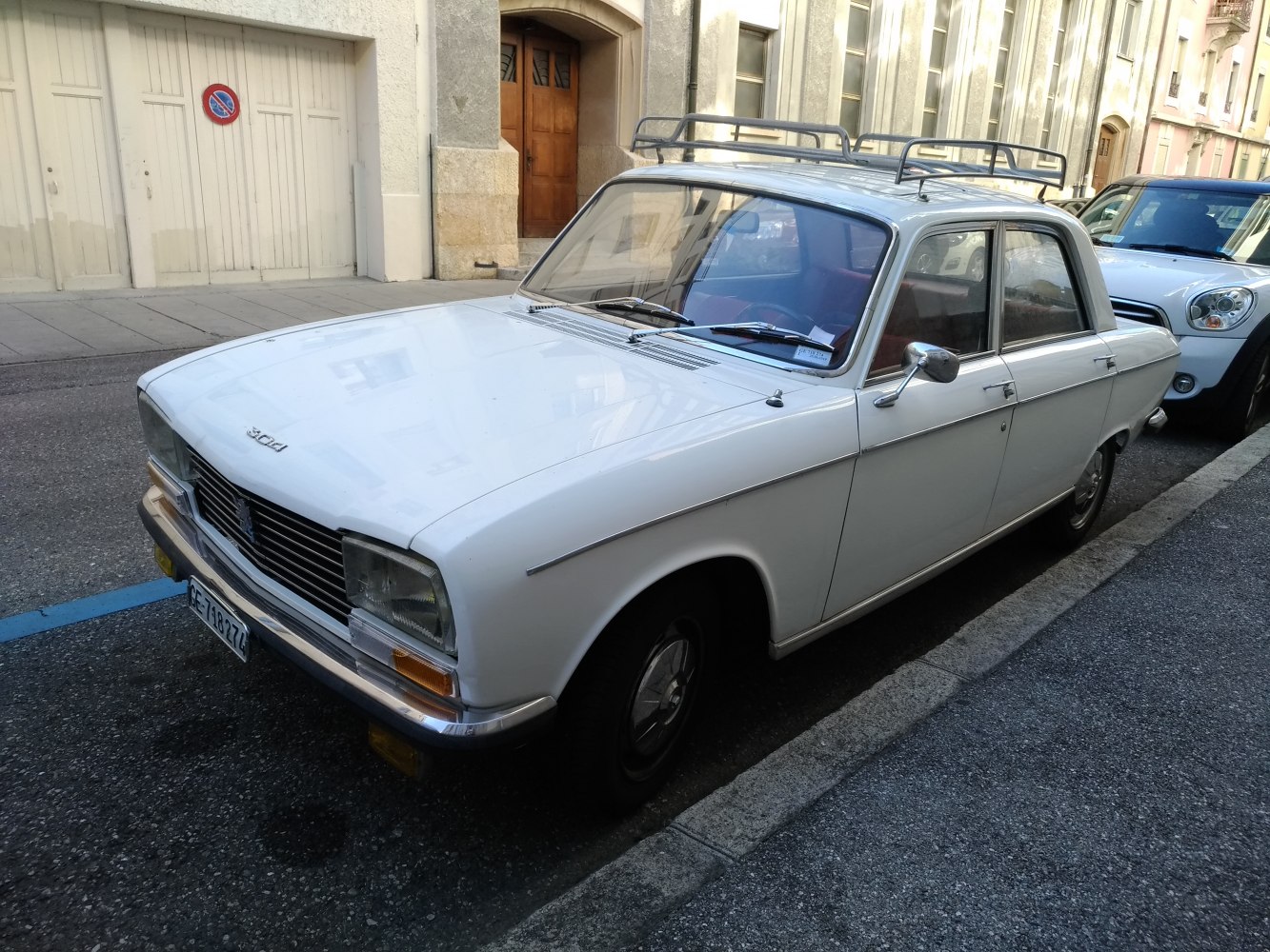 Vintage sedan with rectangular headlights and metal roof rack.