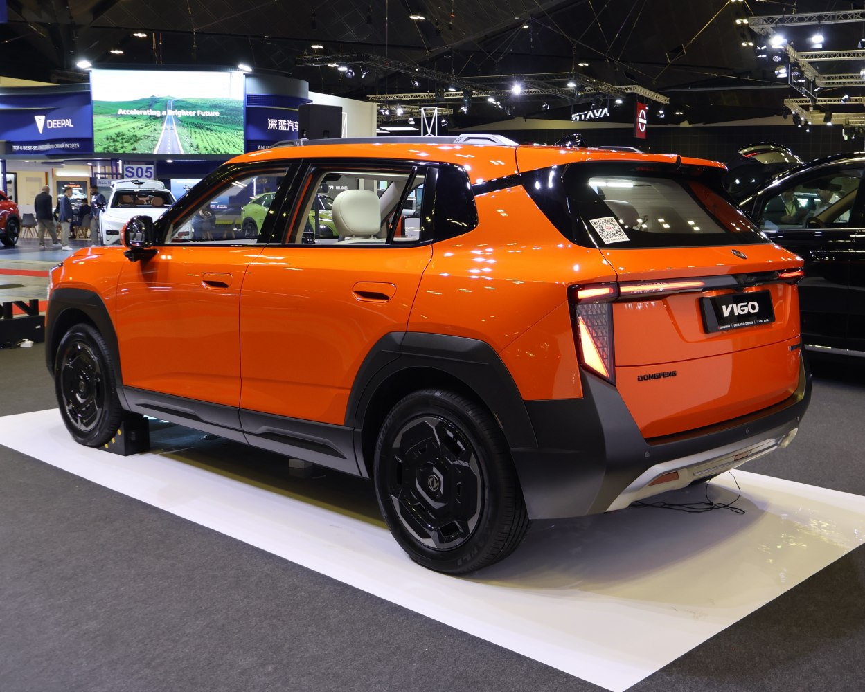 Rear and side view of a bright orange modern SUV