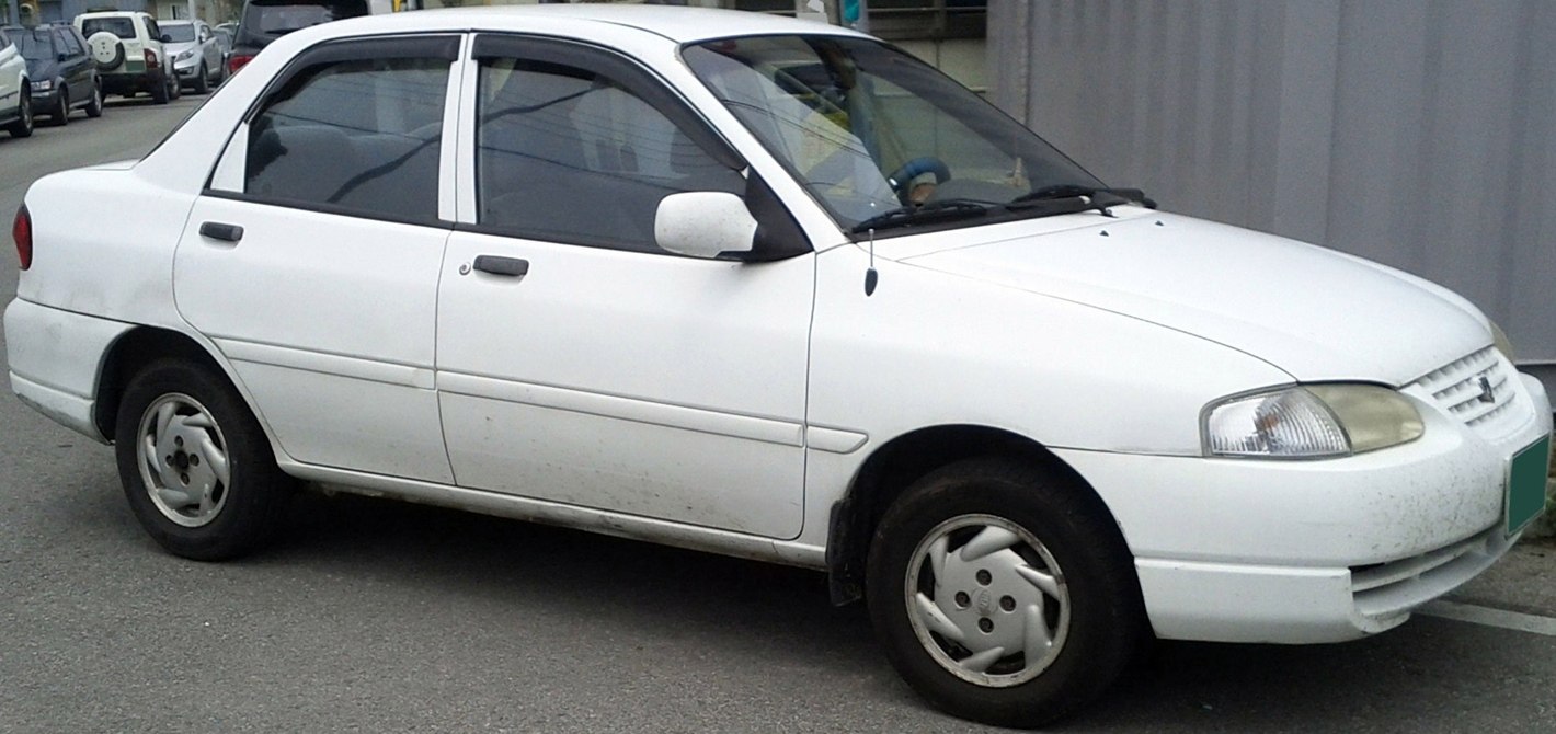 White four-door sedan with rounded headlights and simple design