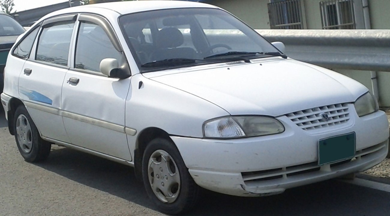 Compact hatchback car front side with grille and headlights.