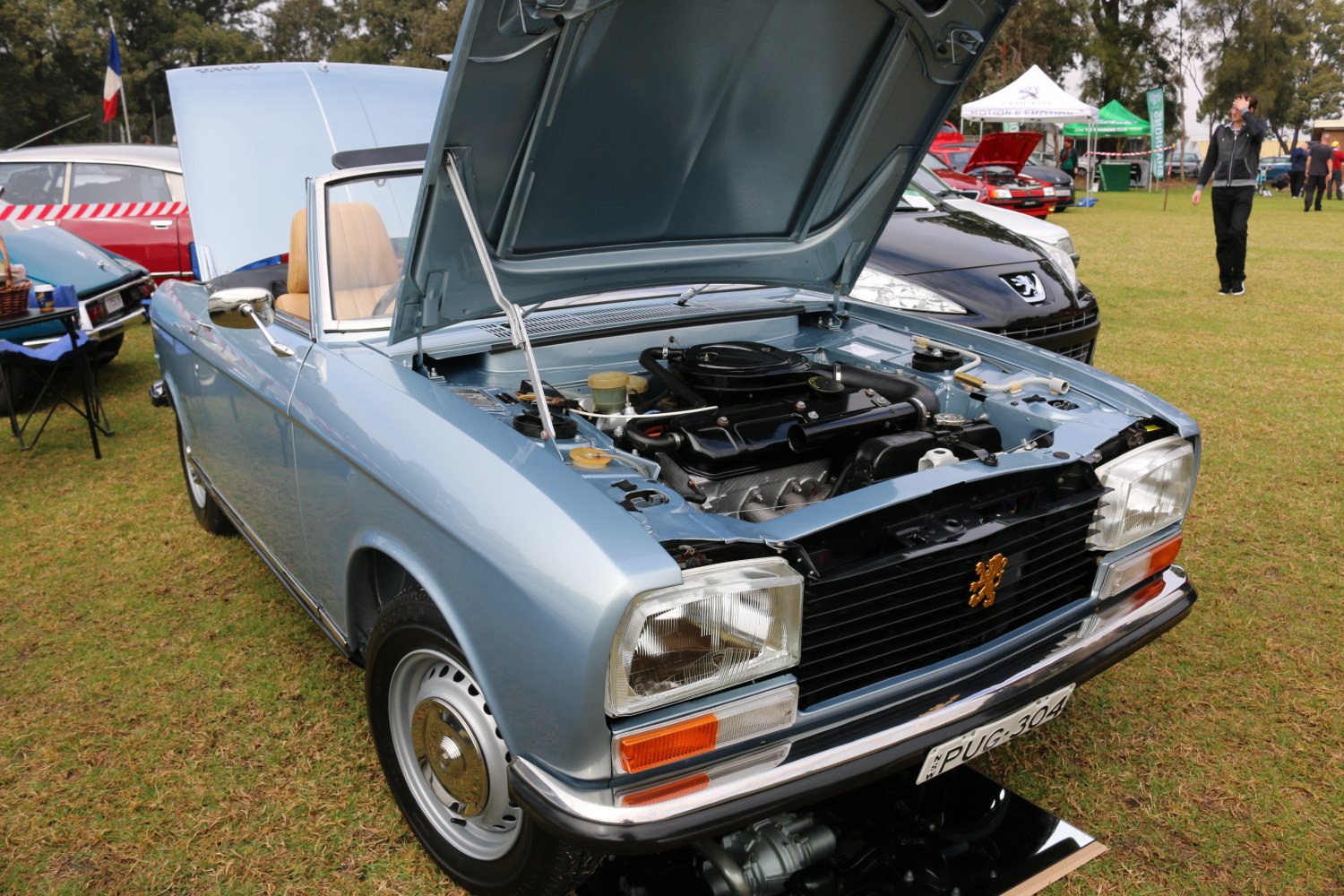 Classic convertible with raised hood showing engine details
