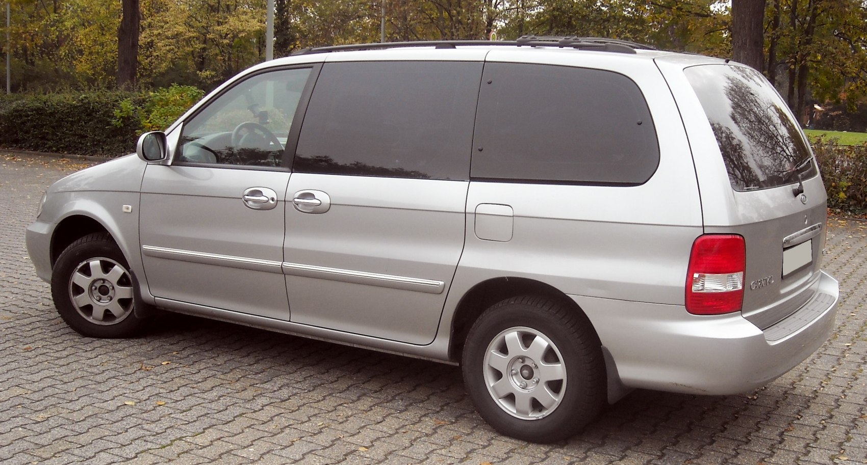 Side view of minivan with sliding doors and tinted windows