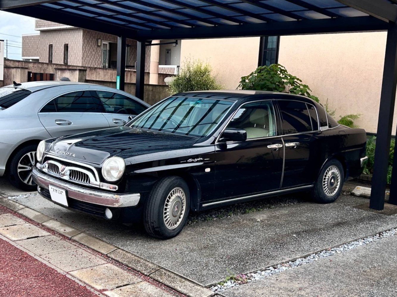 Retro-styled black sedan with unique front grille and side profile