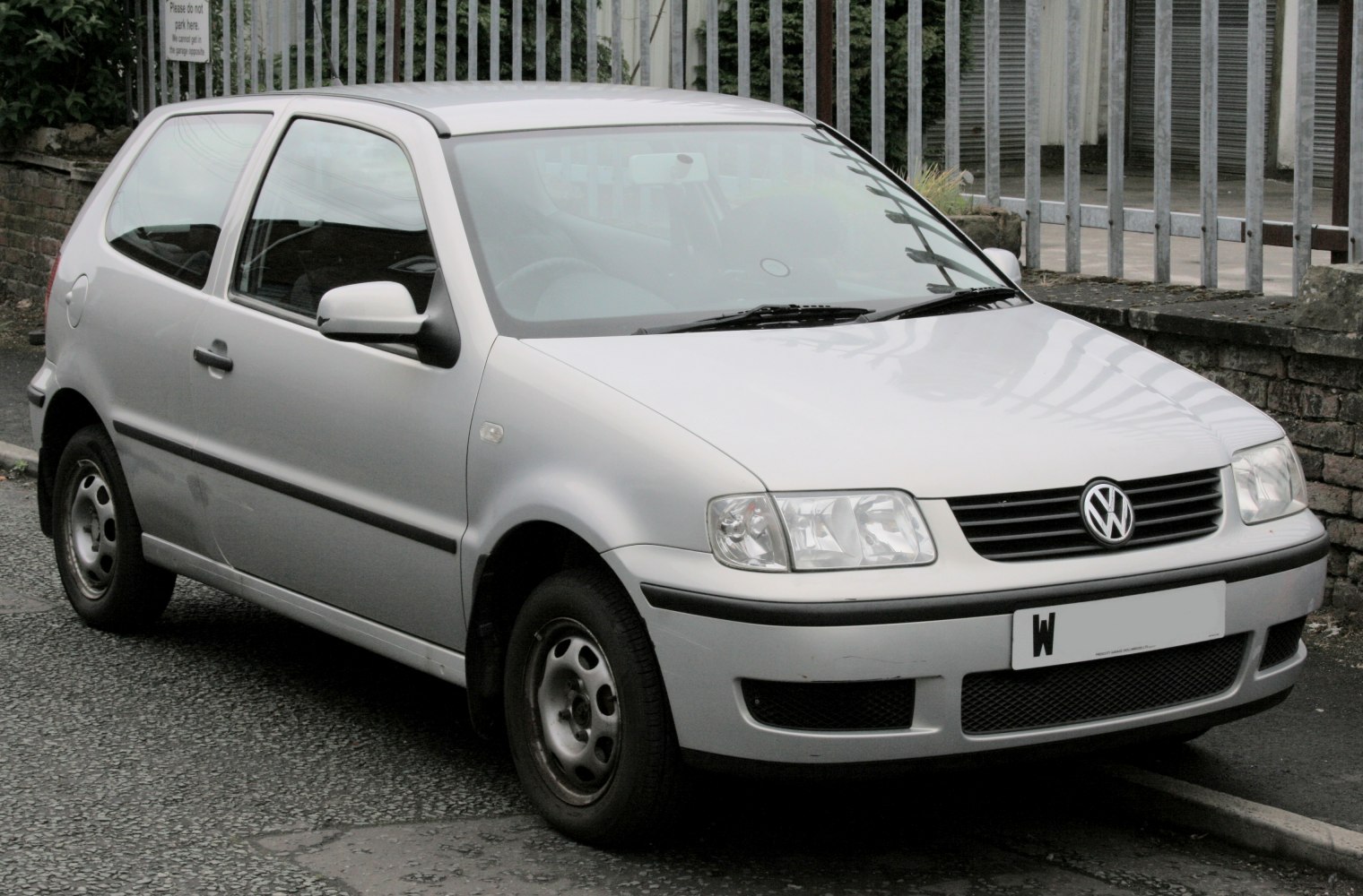 Front angled view of silver compact hatchback with distinct headlights and grille