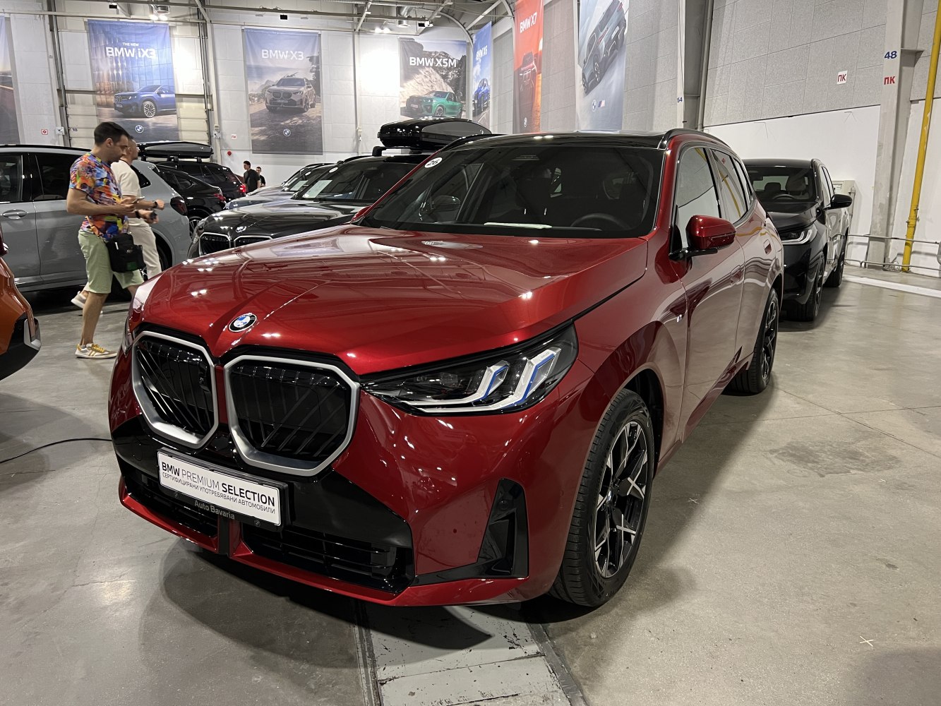 Front view of a red SUV with BMW kidney grille and sleek headlights