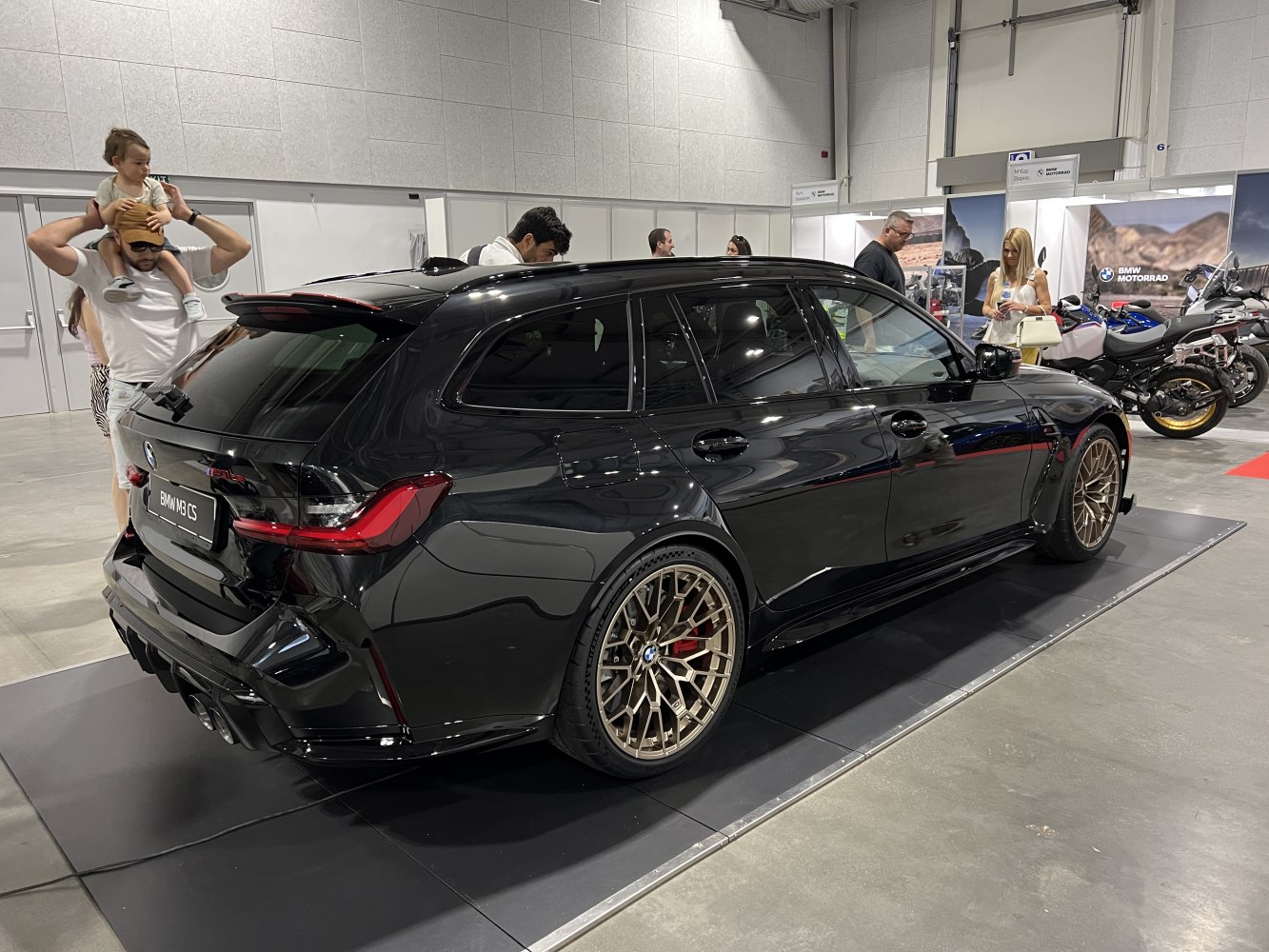 Black luxury performance wagon with bronze multi-spoke wheels and aggressive rear diffuser