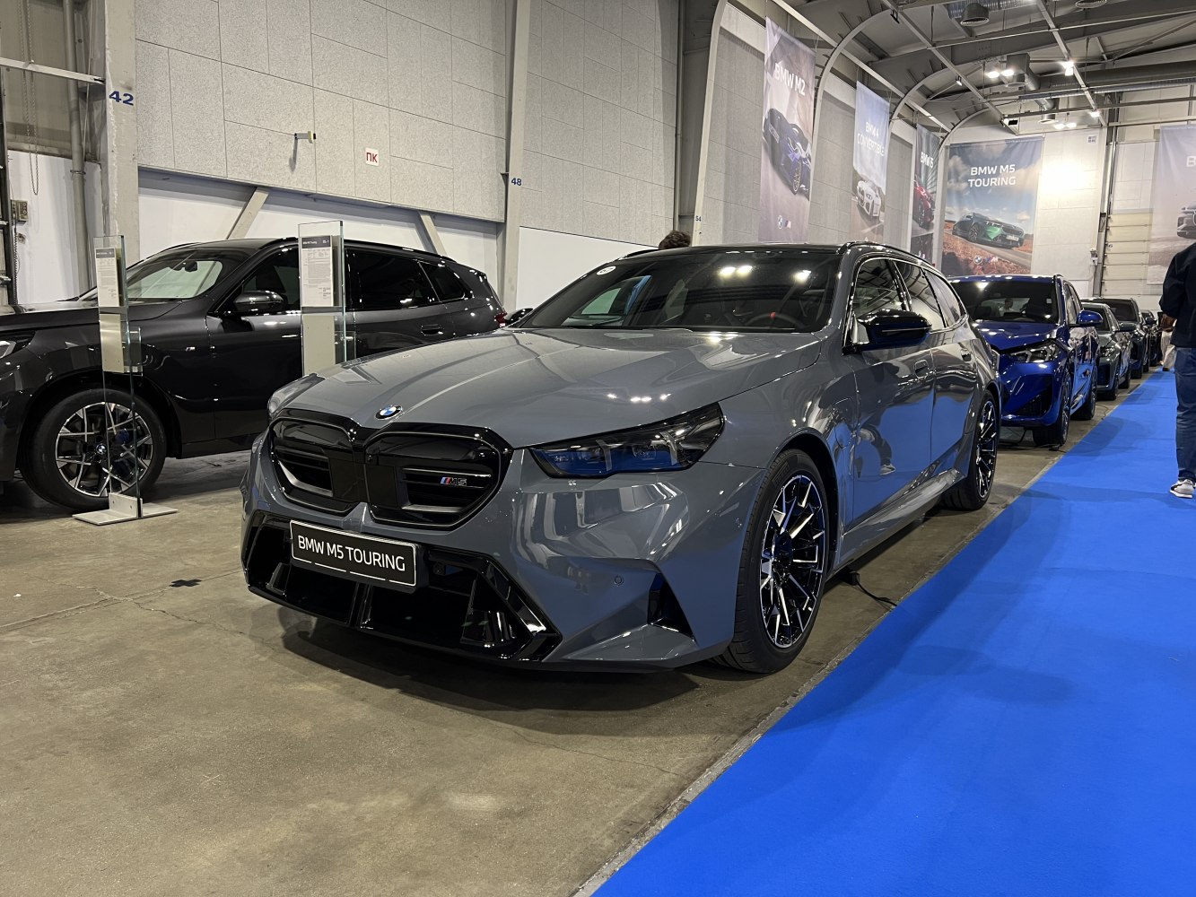 Front and side view of a performance touring vehicle with distinctive grille and sport wheels