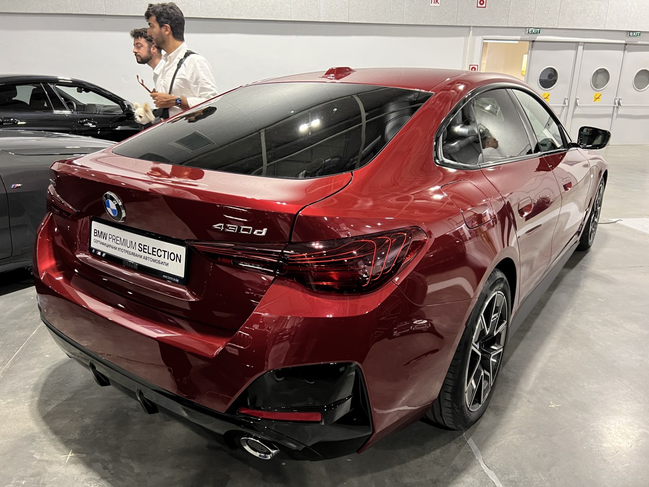 Rear design of a red 4-door gran coupe with distinctive taillights and sporty diffuser.