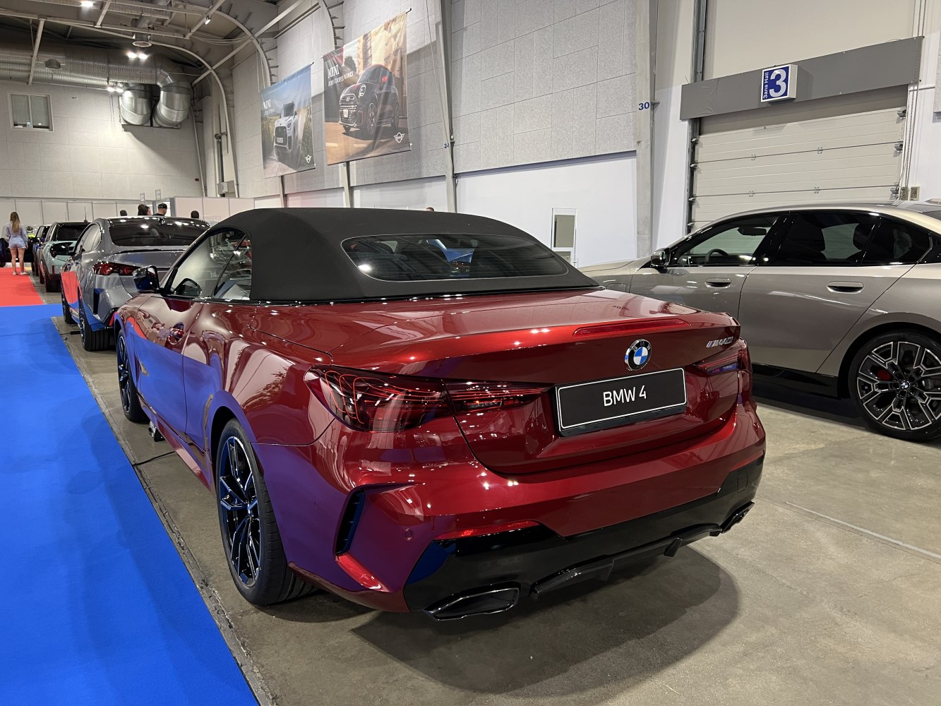 Rear view of convertible with black fabric soft top and dual exhaust