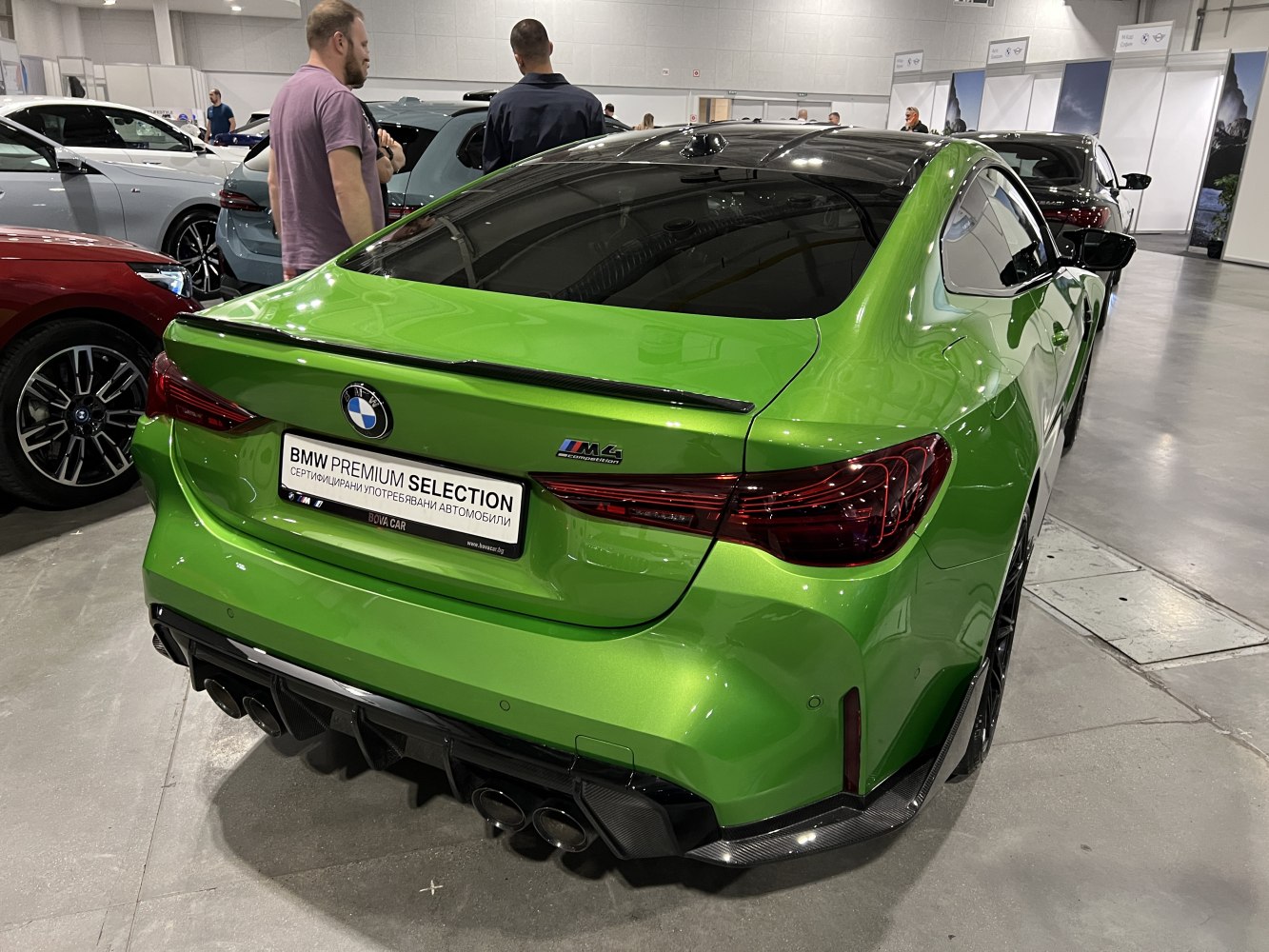 Rear view of sporty coupe with quad exhausts and sleek taillights