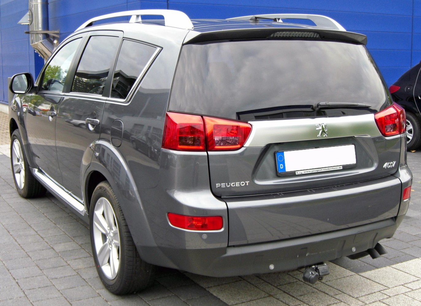 Rear view of SUV with tinted windows and roof rails