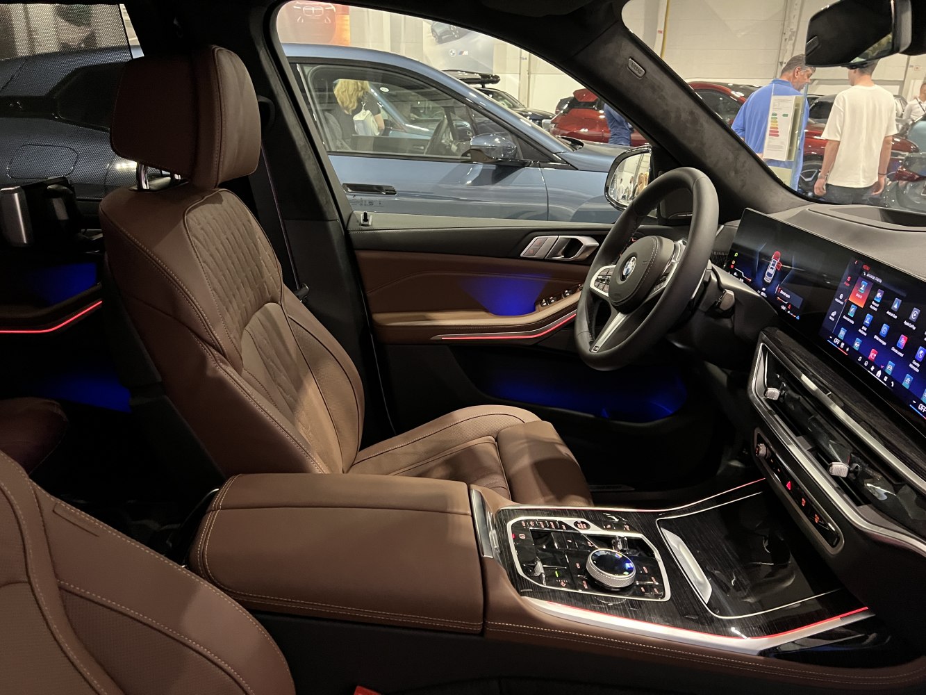Luxury brown leather seats with advanced digital dashboard and ambient lighting.