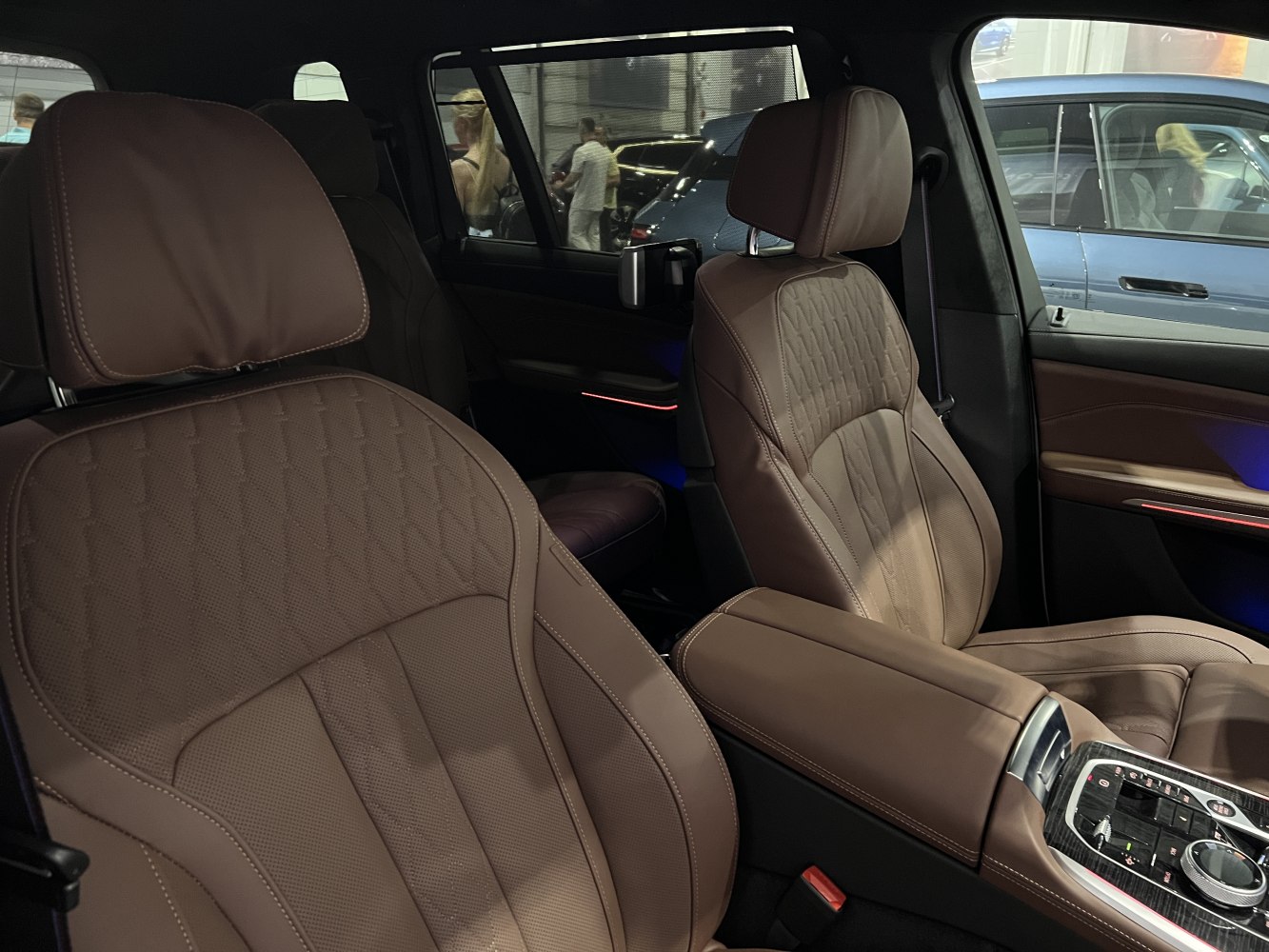 Brown leather front seats with detailed stitching and luxury console controls