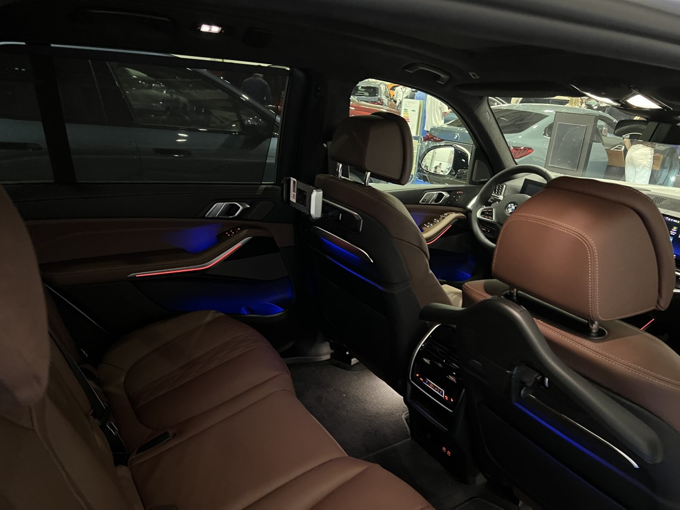 Luxury brown leather seats and ambient lighting inside premium SUV