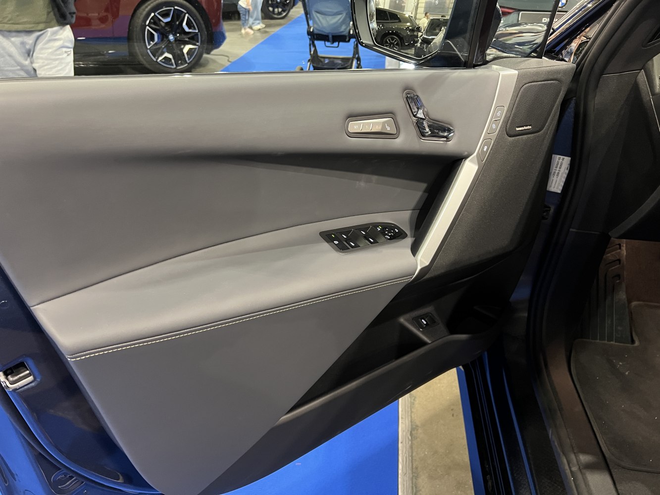 Modern interior door panel with controls and Harman Kardon speaker