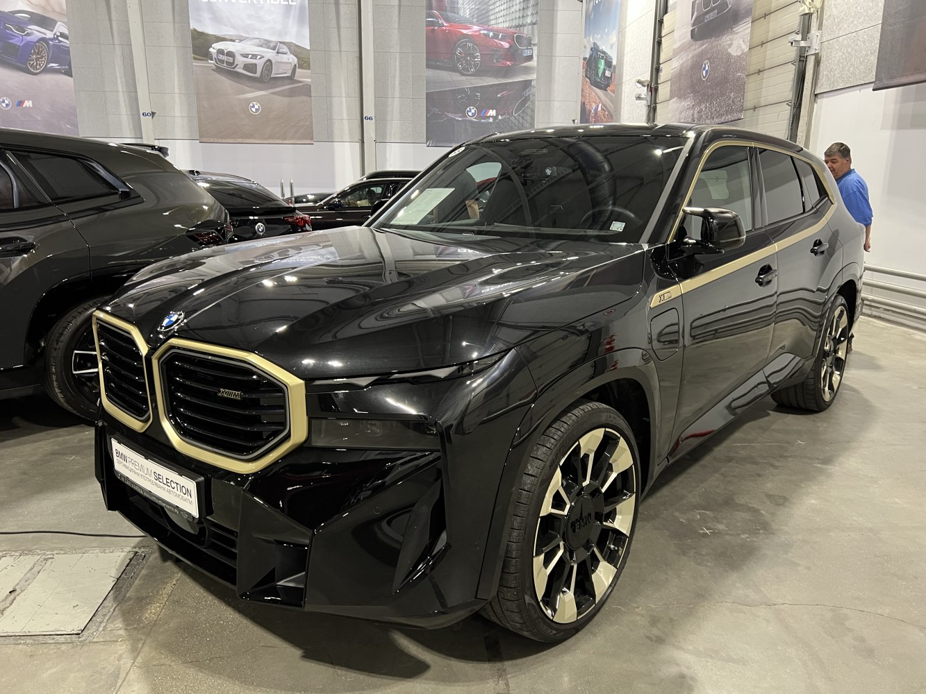 Luxury black SUV with gold-accented dual kidney grille and unique alloy wheels