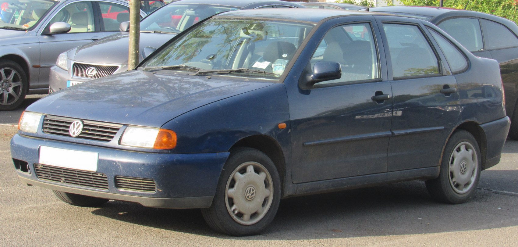 Front side view of a compact hatchback with rounded body and rectangular headlights.