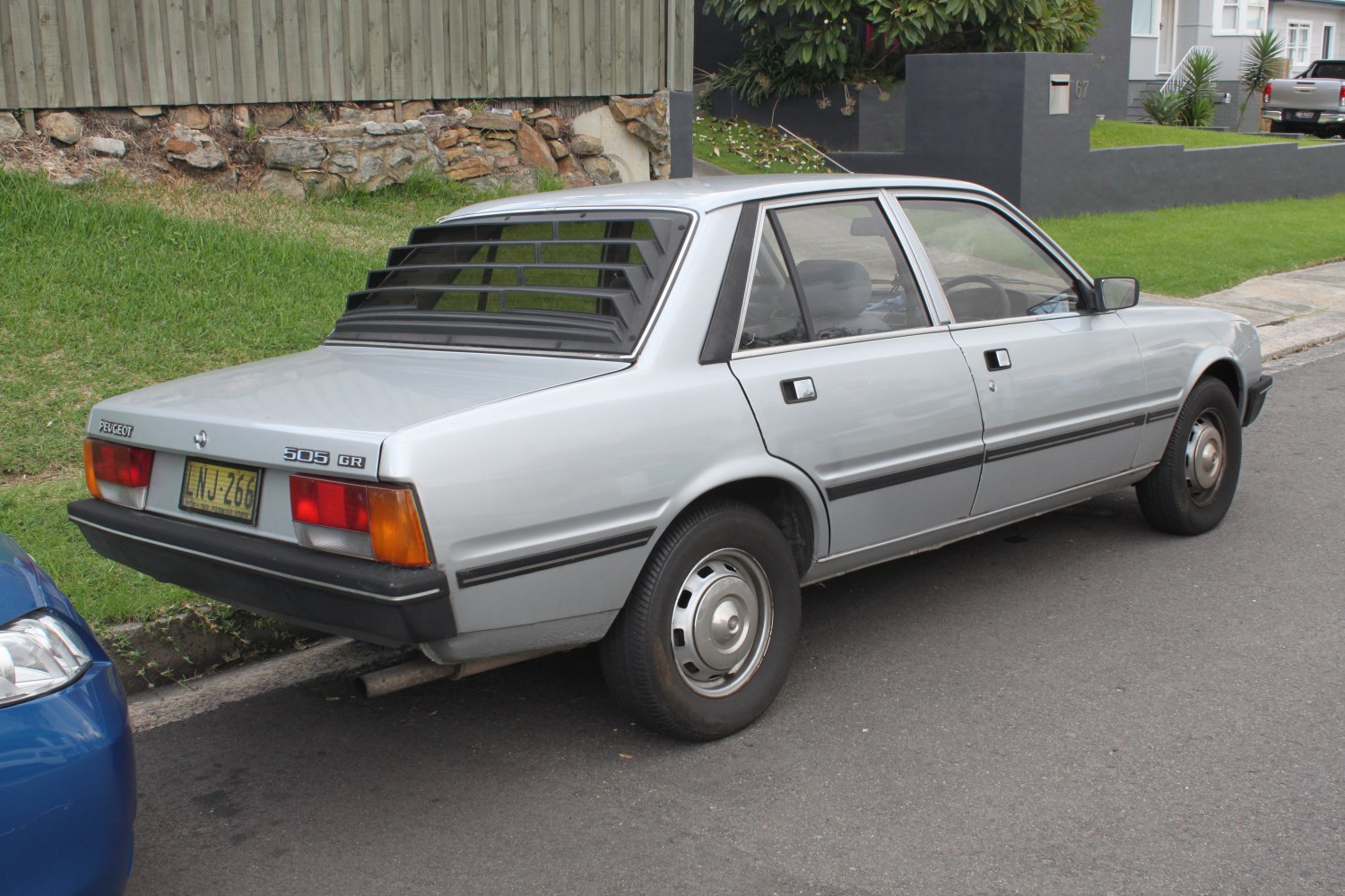 Rear and side view of classic sedan with rear window louvers