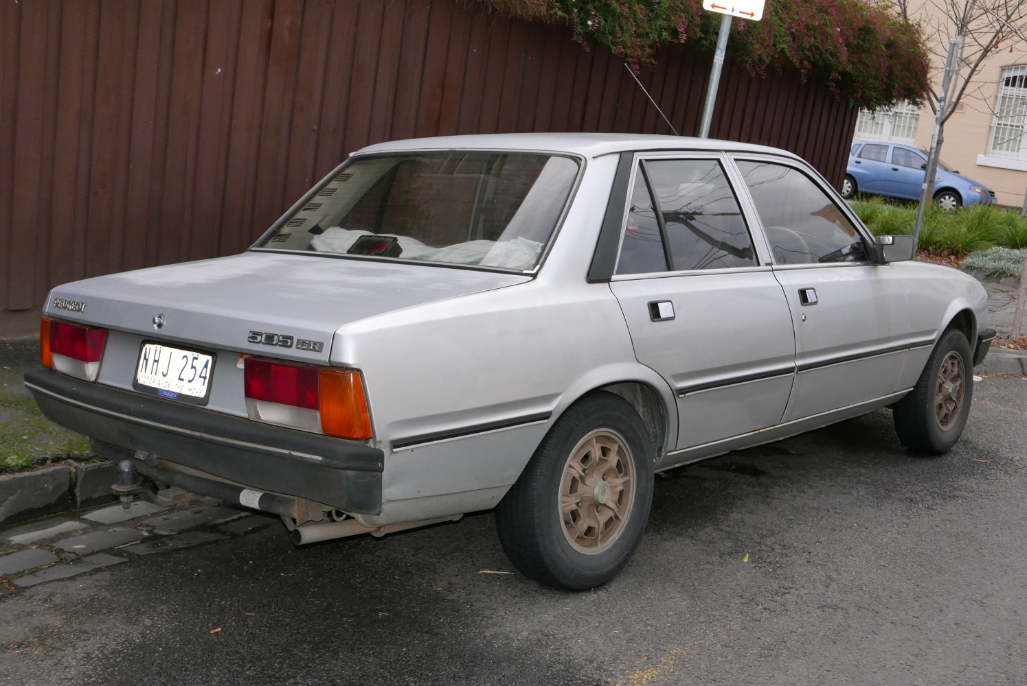 Silver sedan rear side view with original wheels and classic 1980s design