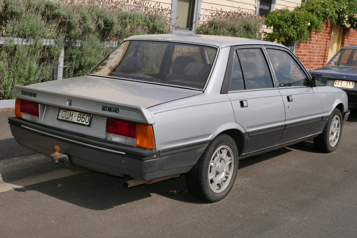 Rear and side view of classic 1980s sedan with distinctive rear lights and alloy wheels