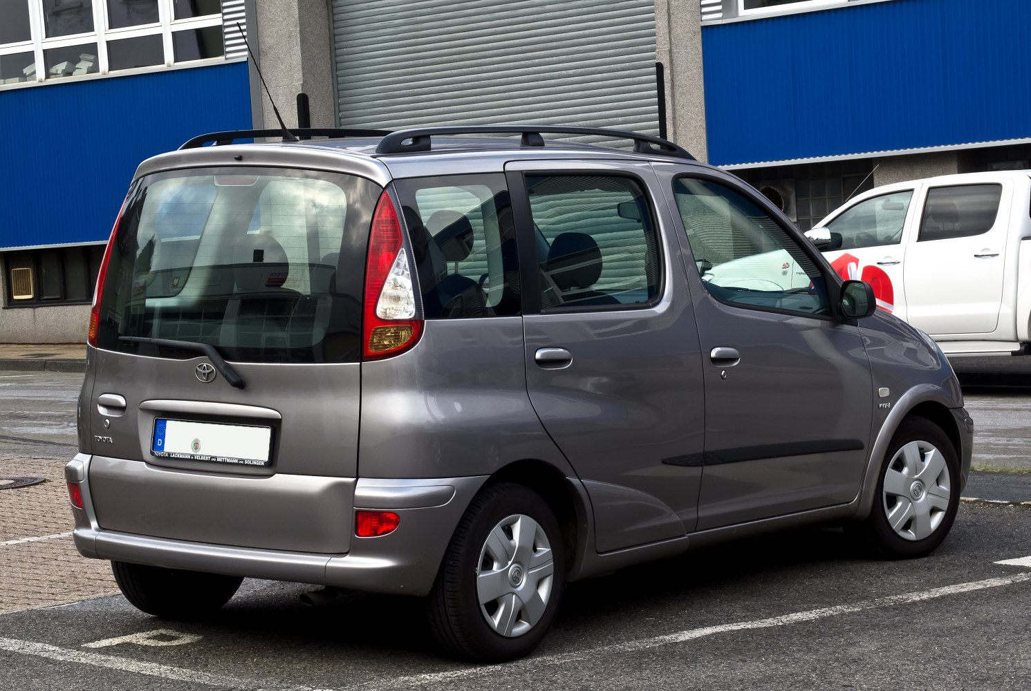 Rear view of compact MPV with vertical tail lights and roof rails