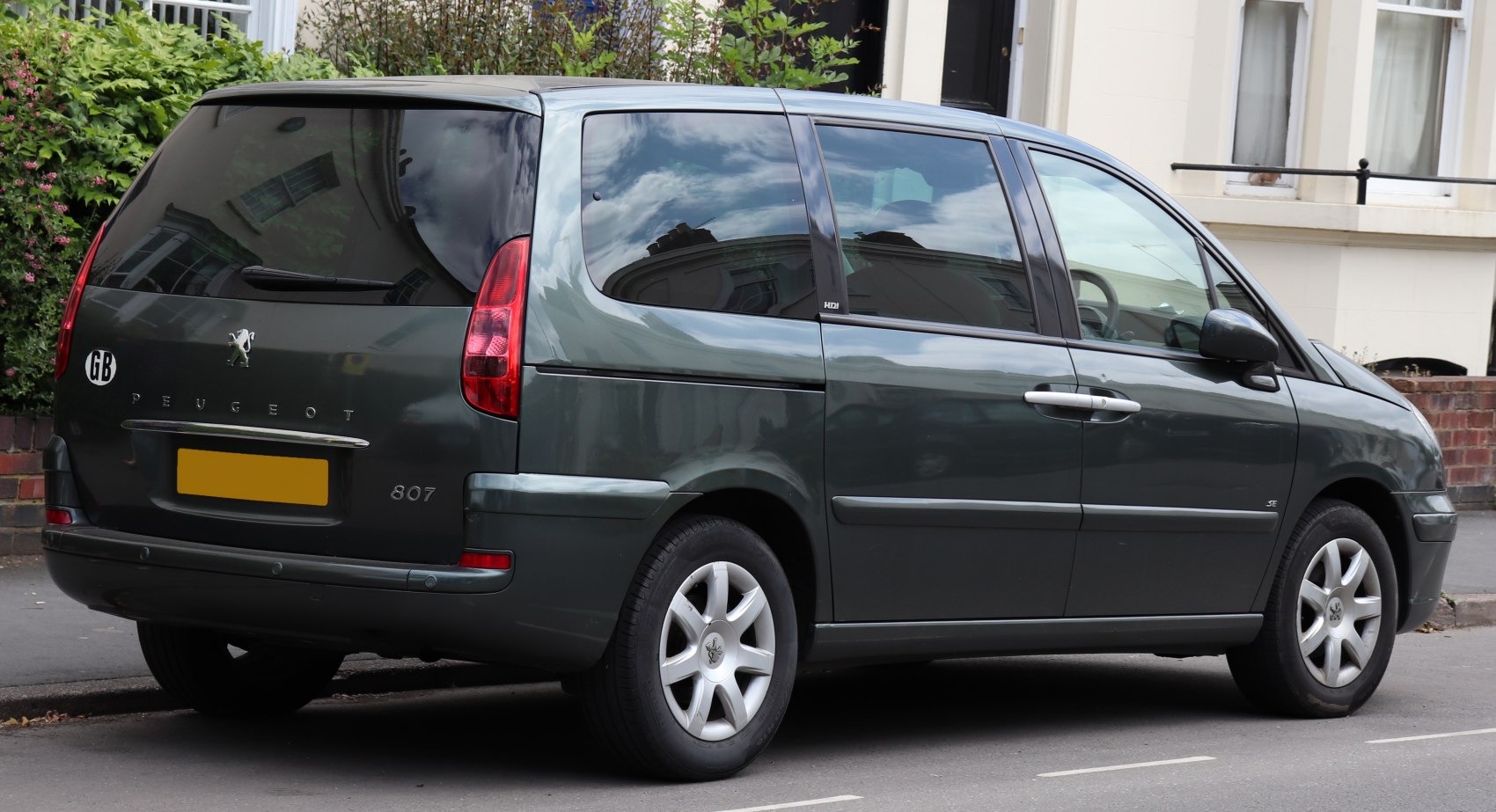 Rear and side minivan view with sliding doors and alloy wheels