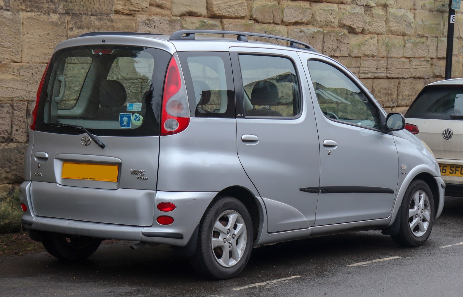 Silver compact MPV with high roof and large rear window.