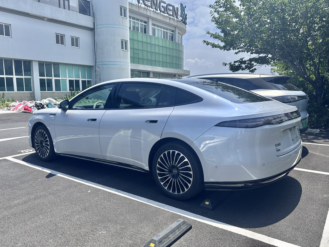 Aerodynamic white sedan with flush door handles and stylish alloy wheels