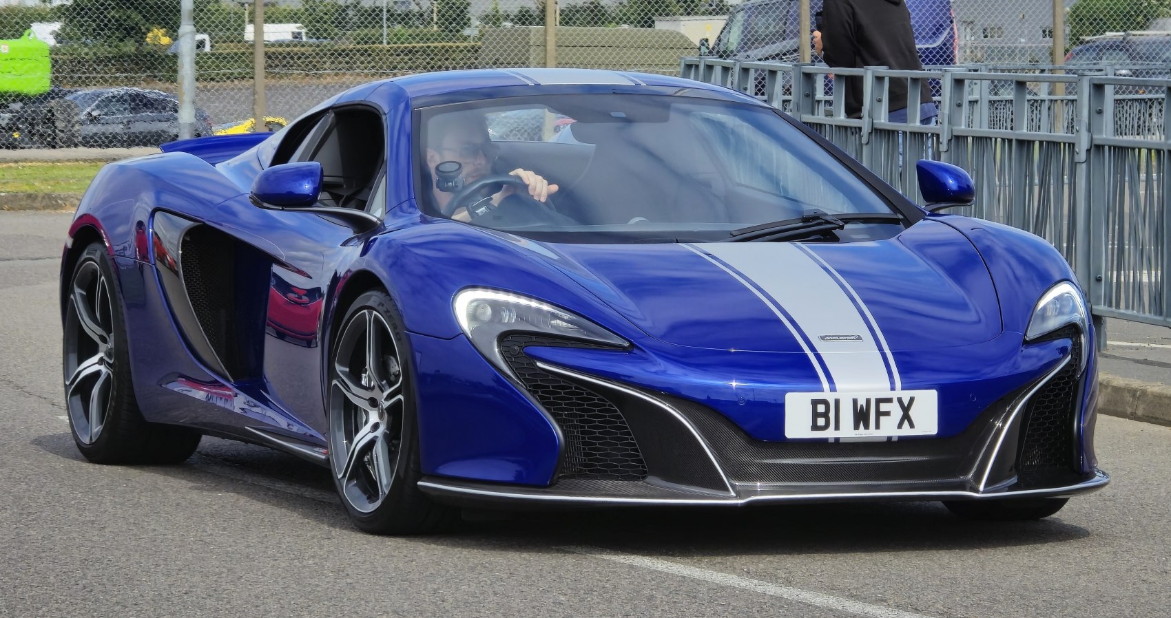 Blue sports car front with racing stripes and aerodynamic design