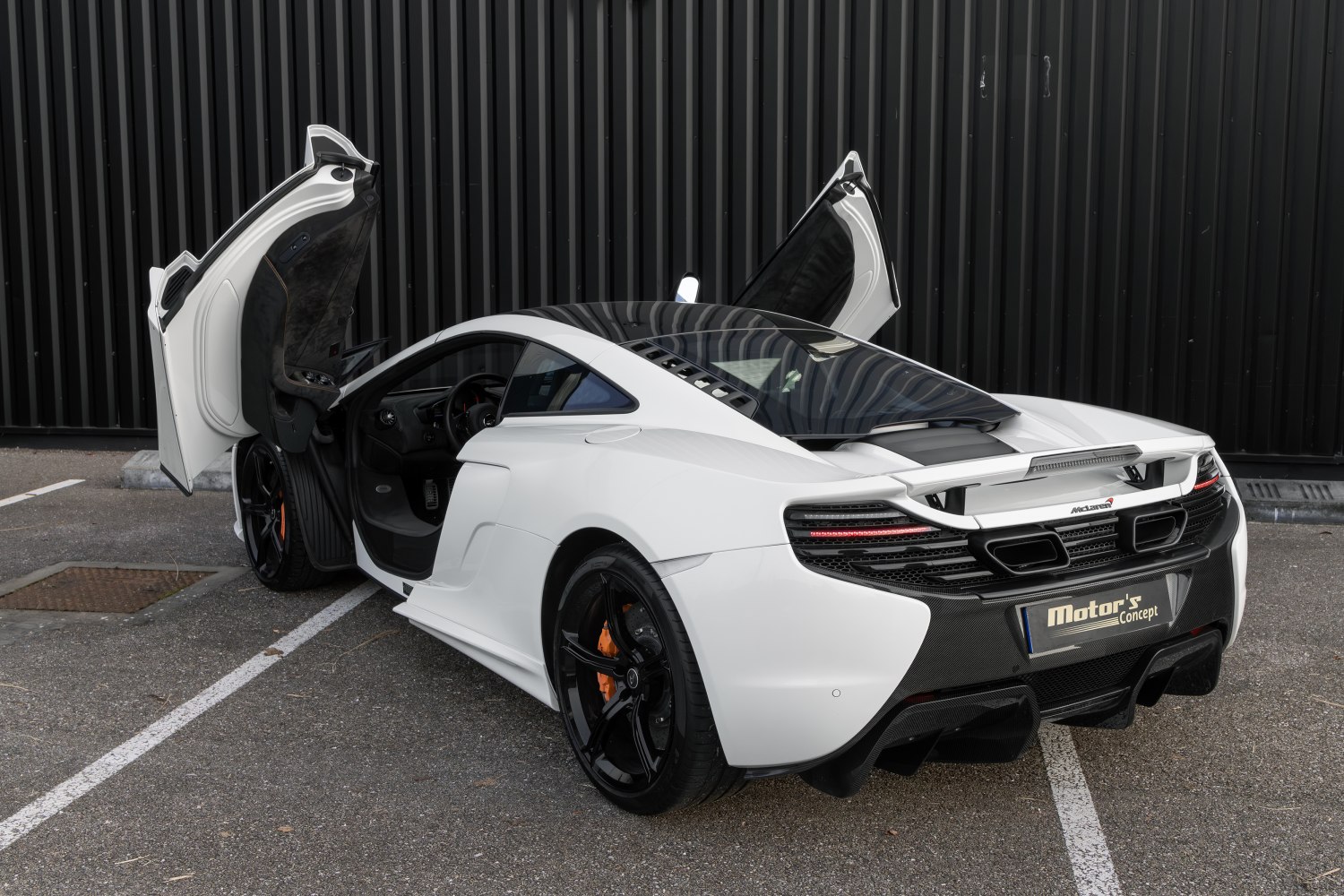 Supercar with scissor doors and aerodynamic rear design