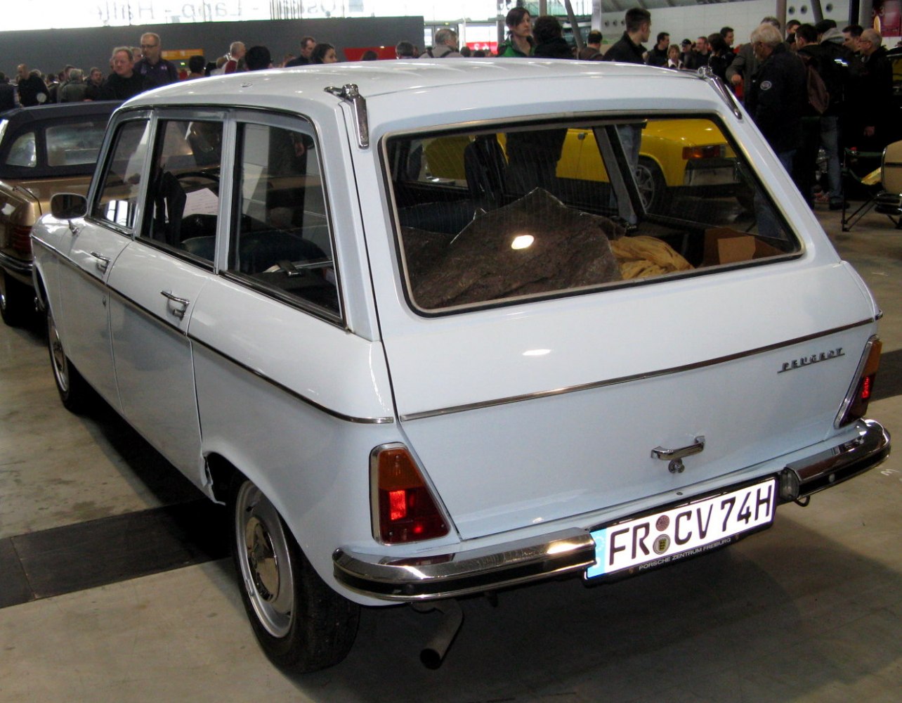 Rear and side profile of classic vintage wagon with large windows and chrome bumpers