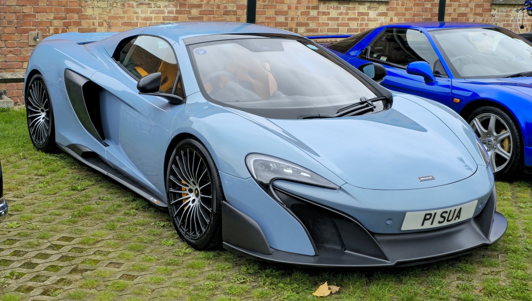 Aerodynamic coupe with aggressive front intake and multi-spoke wheels