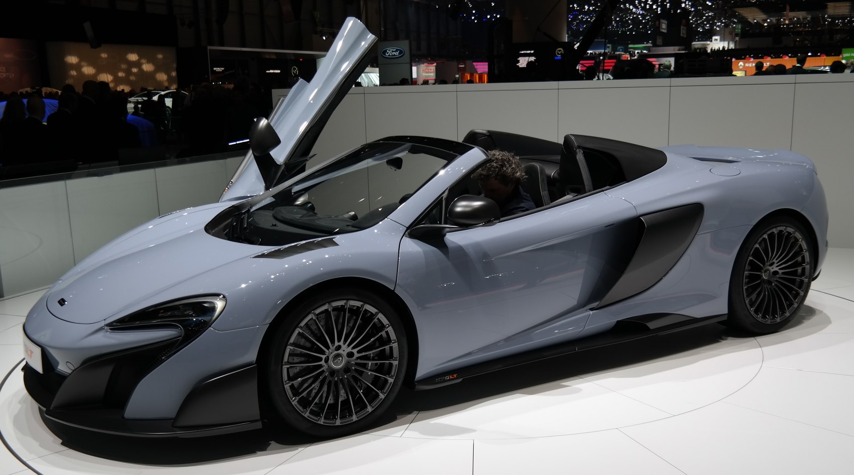 Convertible sports car with dihedral door open and aerodynamic styling