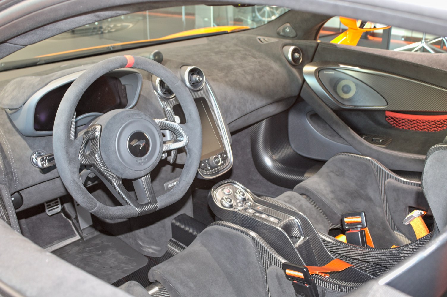 Carbon fiber interior with racing bucket seats and steering wheel.