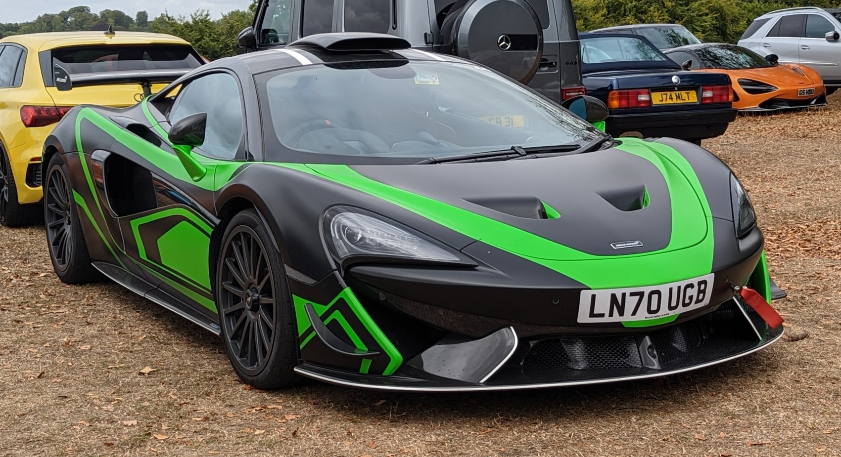 Black and green racing livery with aerodynamic front and carbon fiber details