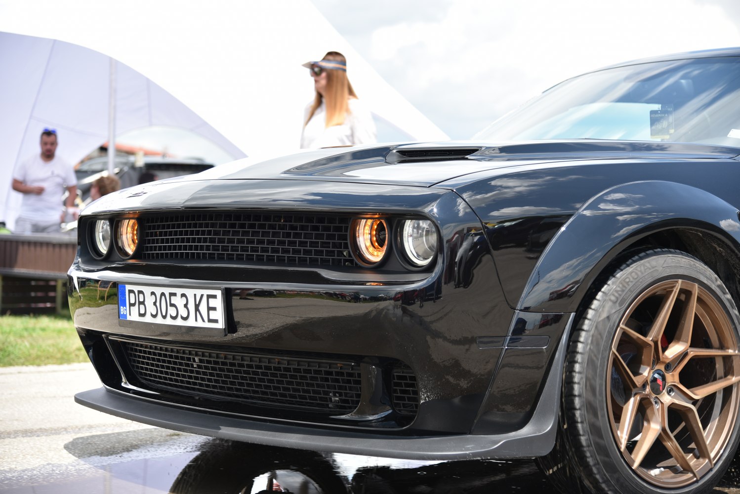Front fascia and bronze alloy wheels of a muscle car.
