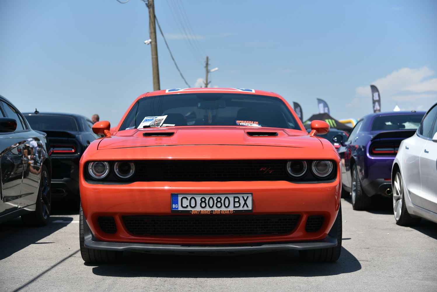 Front view of aggressive muscle car with dual round headlights and R/T grille.