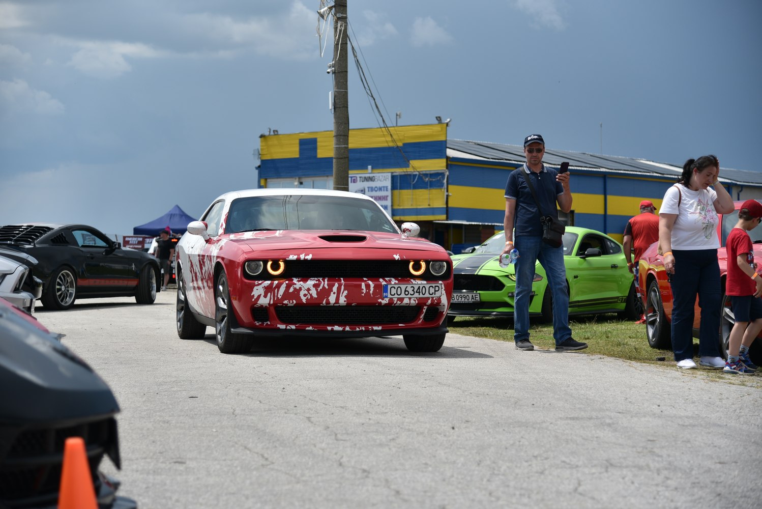 Front view of muscle car with halo headlights and hood scoop