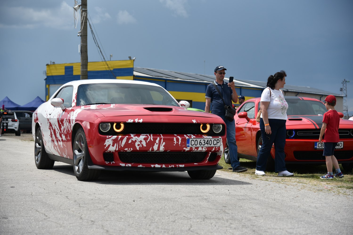 Red and white custom paint facelift Dodge Challenger front with halo headlights