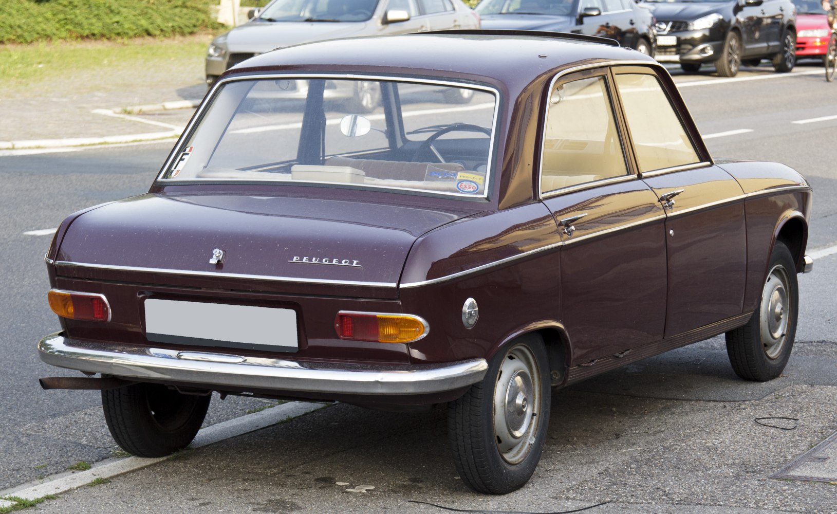 Rounded rear lights and chrome bumper on vintage compact sedan.