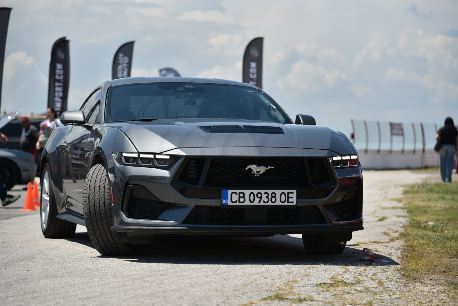 Front view of a 2024 Mustang with aggressive grille and pony emblem