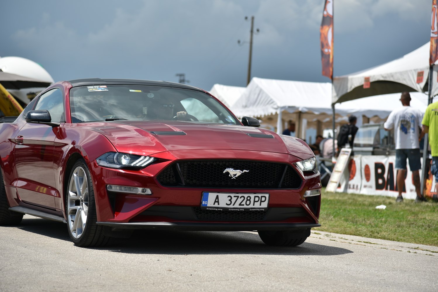 Aggressive front grille with sharp headlights on performance coupe.