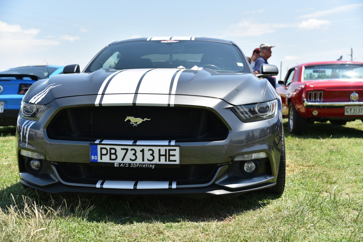 Close-up of front grille with Mustang emblem and white racing stripes