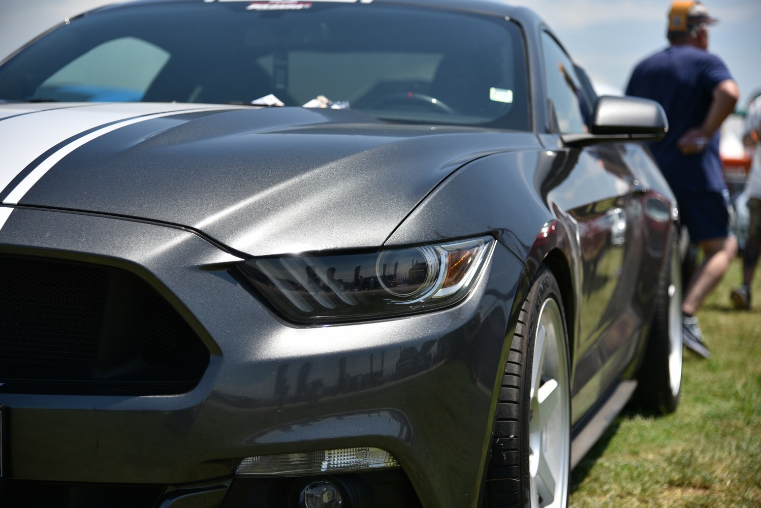 Close-up of front headlight and hood with racing stripes
