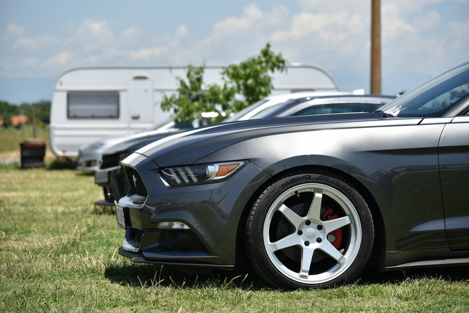 Sleek front headlight and alloy wheel with red brake calipers