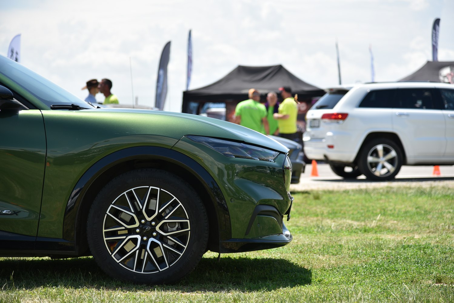 Close-up of front wheel and headlight on a sleek electric SUV