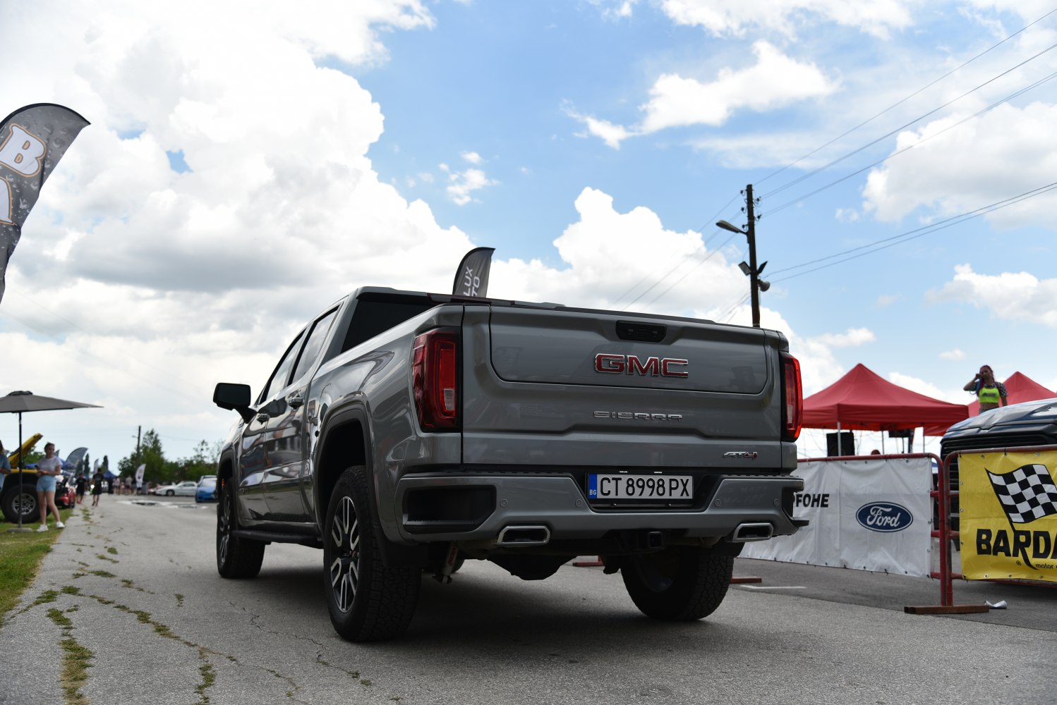 Rear view of a pickup truck showing tailgate, exhaust, and dual rear lights
