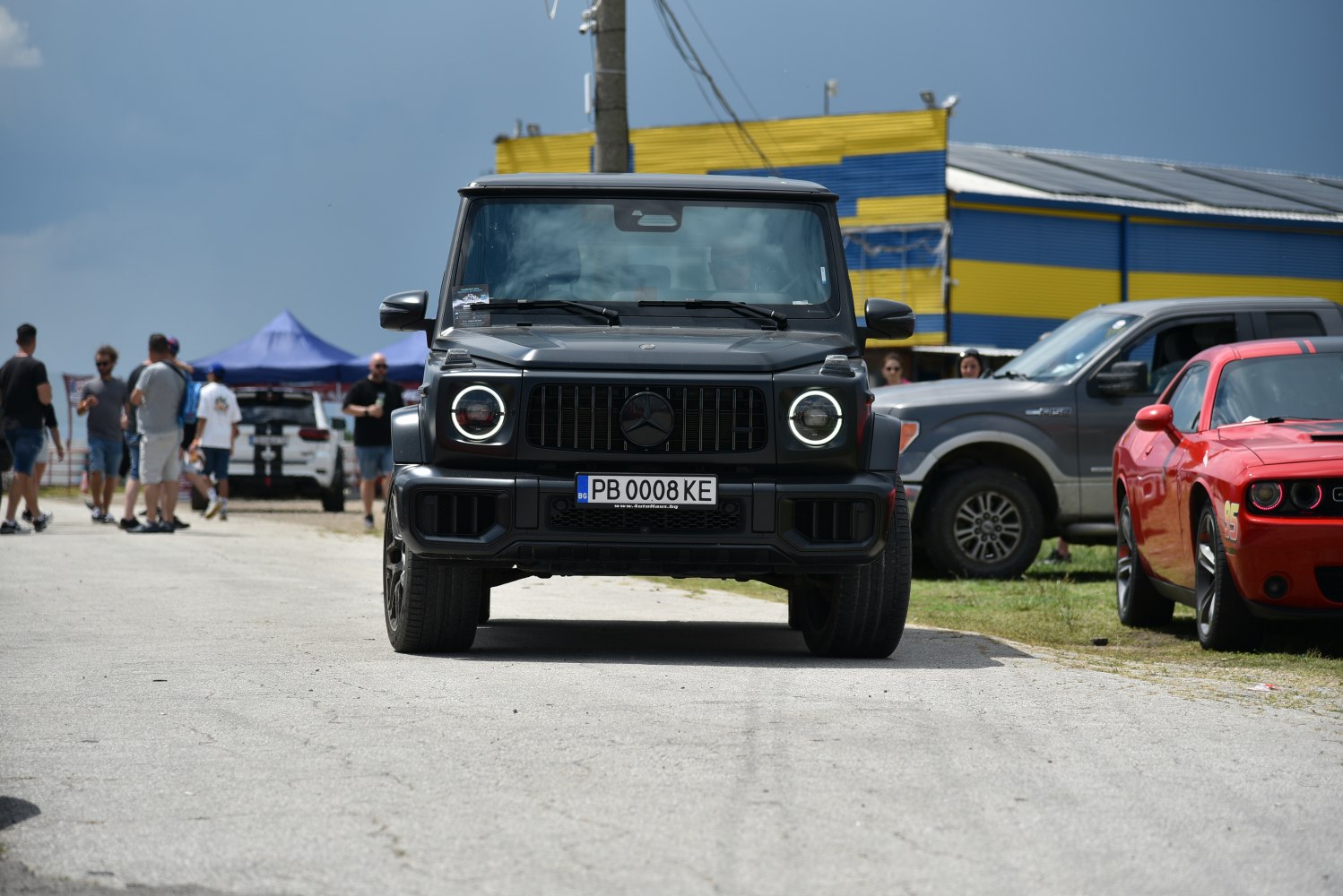 Front view with round LED headlights and prominent grille