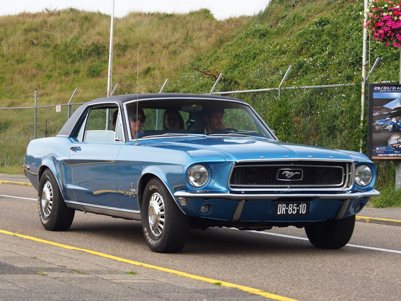 Front view of blue 1967 hardtop coupe with chrome grille and round headlights